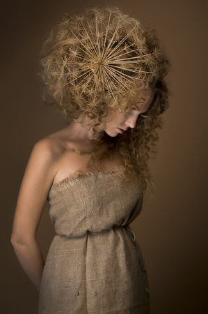 portrait of beautiful curly girl on a beige backgroundの写真素材