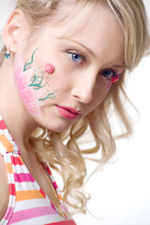 portrait of a young cute girl. pretty blond woman with face art