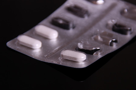white pills on black