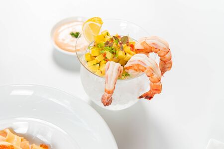 Glass with appetizer shrimp cocktail and salsa sauce on white backgroundの写真素材
