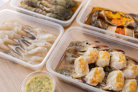 The dish of mix fresh seafood crab shrimp and Mantis shrimps, ready to eat. Wooden backgroundの写真素材