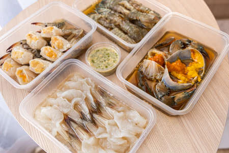 The dish of mix fresh seafood crab shrimp and Mantis shrimps, ready to eat. Wooden backgroundの写真素材