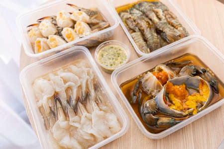 The dish of mix fresh seafood crab shrimp and Mantis shrimps, ready to eat. Wooden backgroundの写真素材