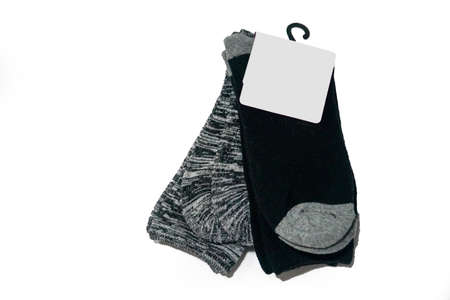 Pair of gray and black socks with label isolated on white background with copy spaceの写真素材