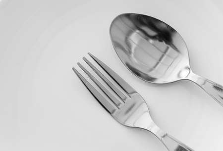 spoon and fork stainless on White plateの写真素材