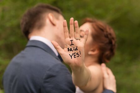 Romantic portrait of young interracial couple in love hugs. Just got engaged.の写真素材