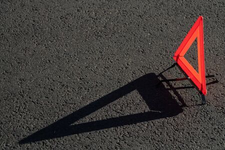 Red triangle of a car on the roadの写真素材