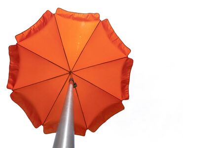Orange beach umbrella isolated on white. Clipping path included. Copy spaceの写真素材