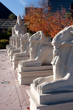 Egyptian statues in a row surrounded by fall colors.の写真素材