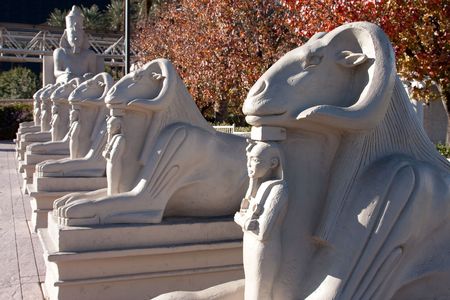 Egyptian statues in a row surrounded by fall colors.の写真素材