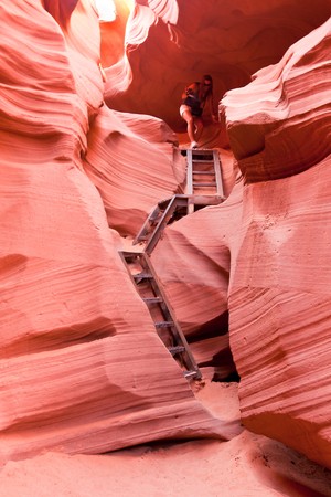 PAGE, AZ - SEPT 13:   Person climbing down the ladders inside Lower Antelope Canyon. Some of the access is via sheer drops. Sept 13, 2010 near Page, Arizona.のeditorial素材