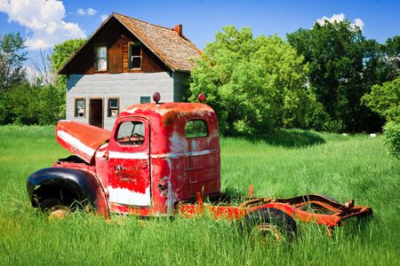 Old rusty red farm truck fading in time.の写真素材