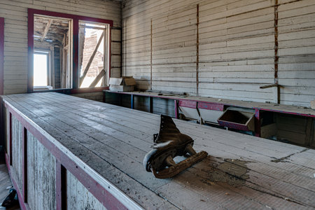 A wooden table with a skate on it. The table is empty and the room is very oldの写真素材