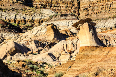 A rocky hillside with a large rock formation in the middle. The rock formation is shaped like a pyramidの写真素材