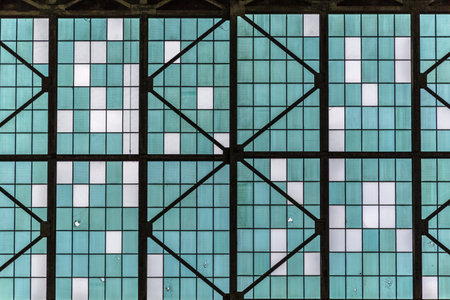 The image is of a building with a blue and white patterned glass ceiling. The pattern is made up of...