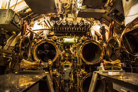 The inside of a ship is filled with many large, shiny, gold-colored machinery. The room is dimly lit, giving it a mysterious and almost eerie atmosphereの写真素材