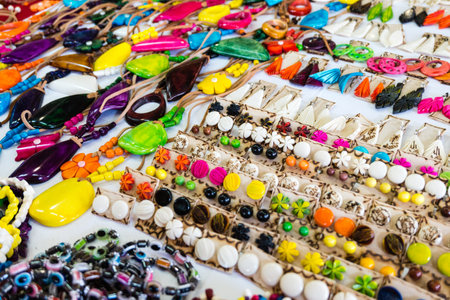 A table full of colorful beads and beads of different shapes and sizes. The beads are arranged in rows and columns, creating a vibrant and eye-catching display. The variety of colorsの写真素材
