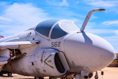 A white fighter jet with the number 562 on the side. The plane is parked in a desert