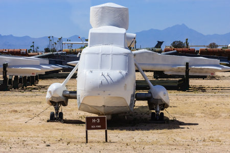 A white helicopter is parked in a field with a sign that says H-3. The scene is quiet and peaceful,...