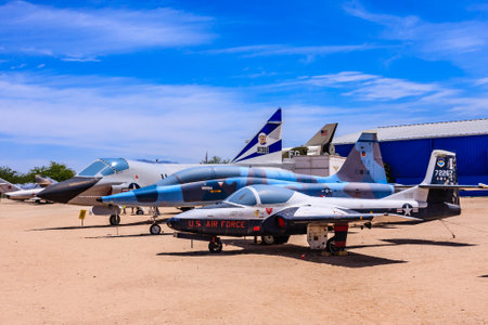 A US Air Force jet is parked next to another jet. The two jets are blue and white