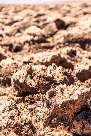 A rocky desert landscape with a few small rocks scattered throughout. Scene is desolate and barrenの写真素材