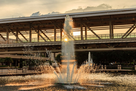 A large fountain with water shooting up into the air. The water is spraying out of the center of the...