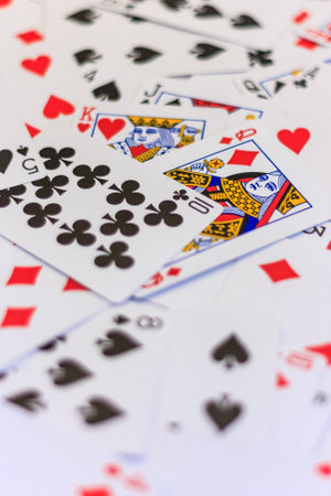 A pile of playing cards with a King and Queen in the middle. The King and Queen are surrounded by a large number of other cardsの写真素材
