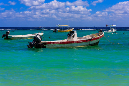 A boat with the word "Salvador" on it is in the water. The water is blue and the sky is clearの写真素材