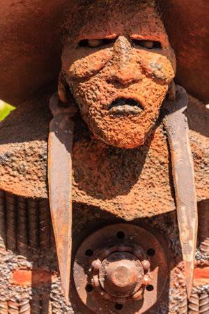 A face made of metal. The face has a very angry expressionの写真素材