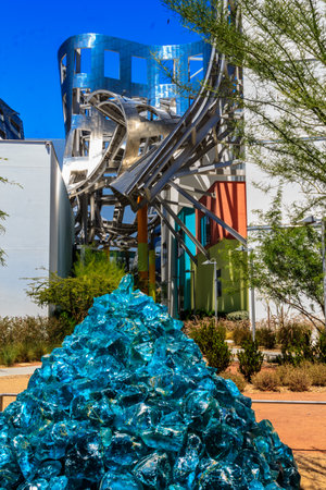 A large blue sculpture made of glass sits in front of a building. The sculpture is made up of many small pieces of glass, creating a unique and eye-catching designの写真素材