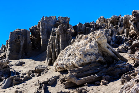 A rocky hillside with a large rock in the middle. The rock is surrounded by smaller rocks and the hillside is barren. Scene is desolate and lonelyの写真素材