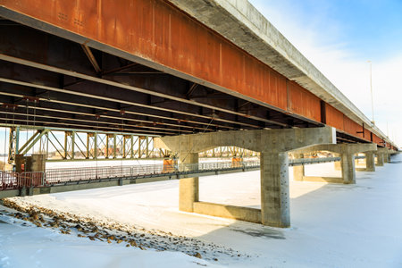 A bridge with a lot of metal and concrete. The bridge is very long and has a lot of pillarsの写真素材