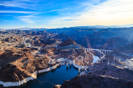 A beautiful mountain range with a large body of water in the middle. The water is surrounded by mountains and the sky is clear and blueの写真素材