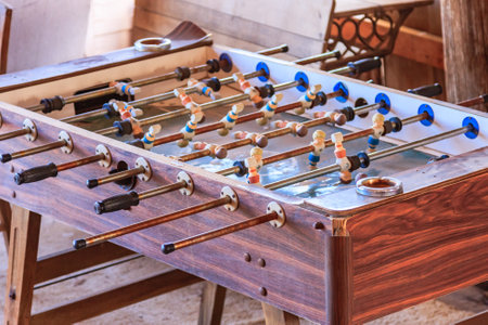 A wooden table with a few other balls.