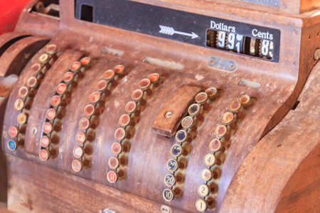 An old fashioned cash register with a price of 9.8 cents. The register has a black arrow pointing to the priceの写真素材