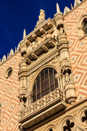 A building with a window and a statue on top. The window is open and the building is oldの写真素材