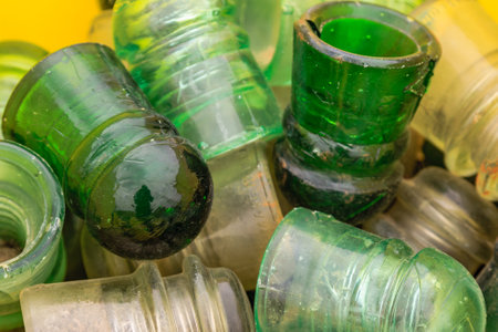 A pile of green and white glass jars. The jars are all different sizes and shapesの写真素材