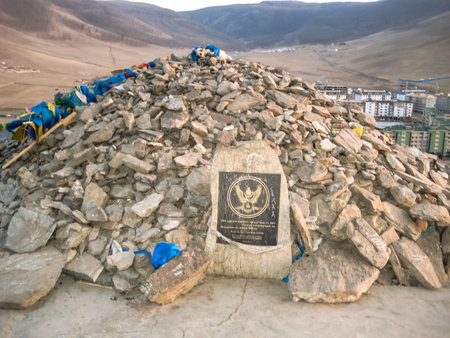 A pile of rocks with a sign on top. The image has a sense of importance and significance, as the sign represents a country.の写真素材