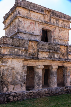 A large stone building with a window on the side. The building is old and has a lot of detailの写真素材