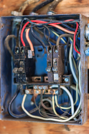 A blue box with wires coming out of it. The box is old and has a lot of wires coming out of it