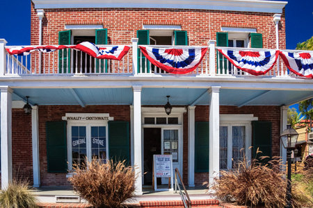 A brick building with a red, white and blue banner hanging from the balcony.の写真素材