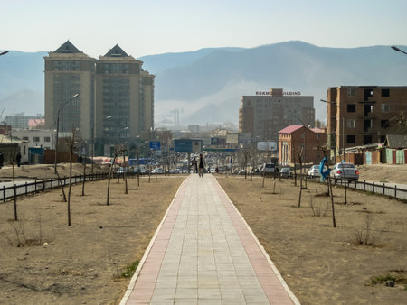 A city street with a sidewalk and a path. The sidewalk is empty and the path is emptyの写真素材