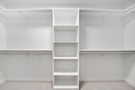 White closet with shelves and racks. The closet is empty and has a clean, minimalist lookの写真素材