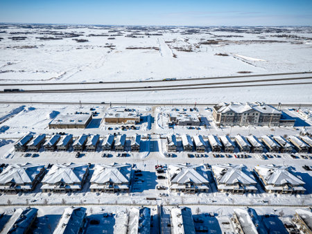 Snowy cityscape with many buildings and a highway in the background. The buildings are mostly empty and covered in snowの写真素材