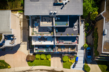 House with a large patio and a pool. The house has a lot of windows and a balcony