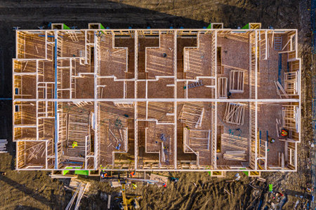 Construction site with a large building in the background. The building is being constructed with a lot of people working on itの写真素材