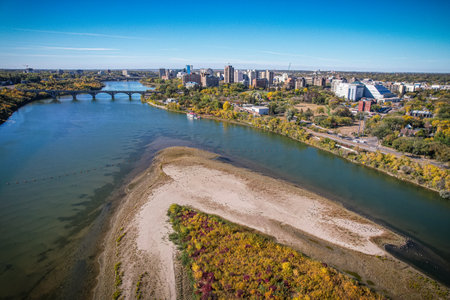 City with a river running through it. The river is wide and the city is full of buildingsの写真素材