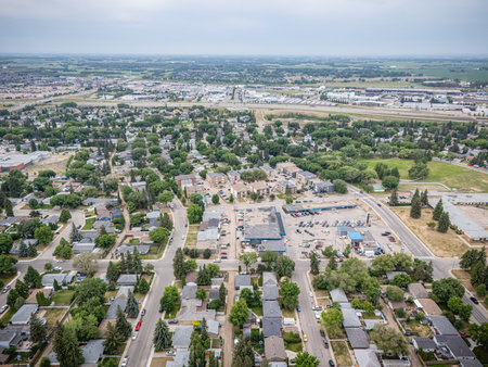 City view from above with a lot of houses and cars. The houses are mostly small and the cars are parked on the streetの写真素材