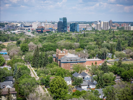 City view with a large building in the middle. The city is full of trees and housesの写真素材