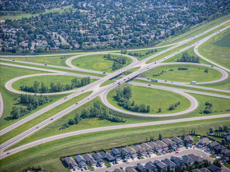 Freeway with a large diamond shaped interchange in the middle. The freeway is surrounded by houses...